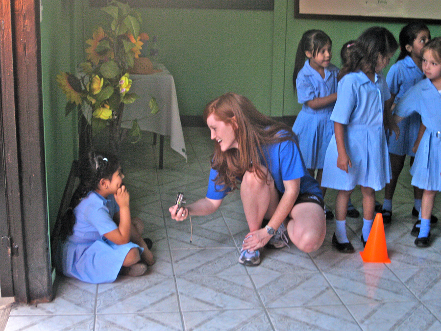 Trip participant playing with school kids